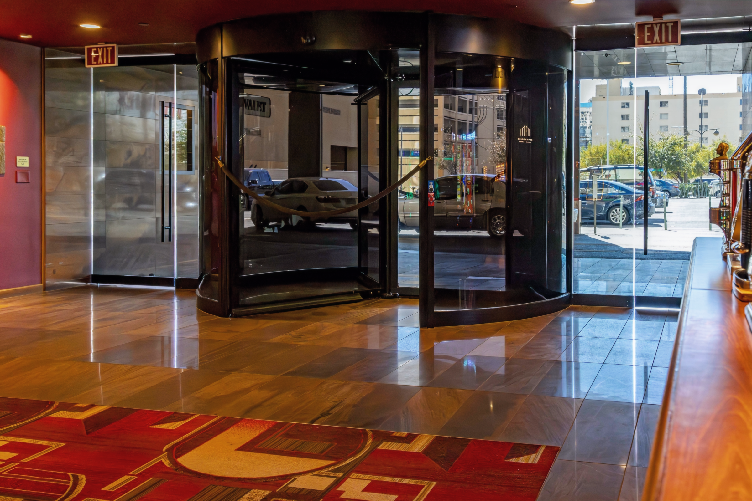 Golden Gate Hotel lobby with polished marble floor tile and revolving entrance doors.